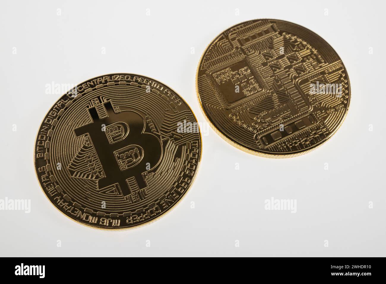 Two Bitcoin coins, front and back, white background, Stock Photo