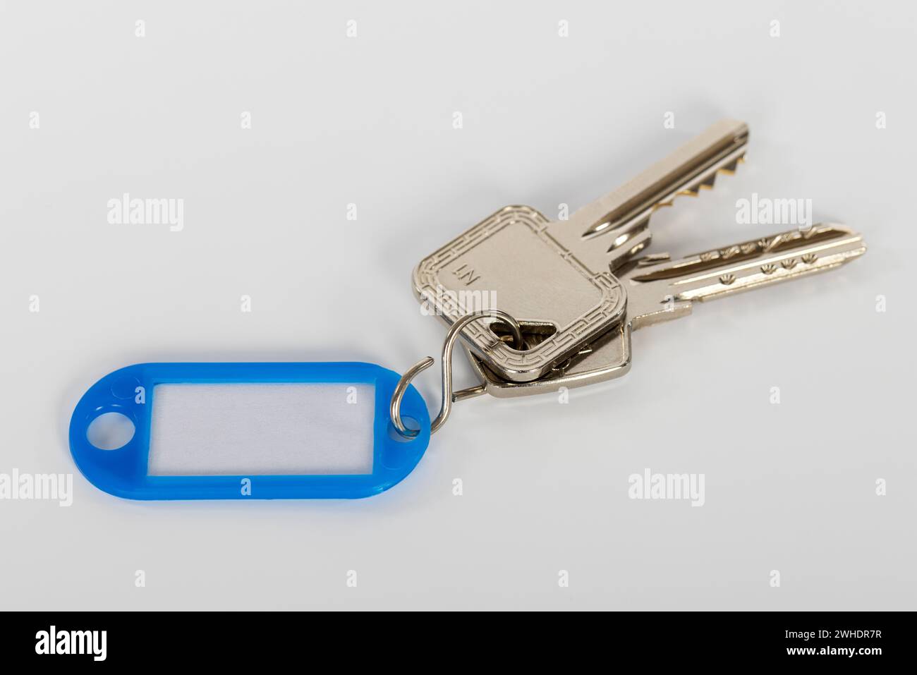 Key ring with blue key fob, without lettering, white background, Stock Photo