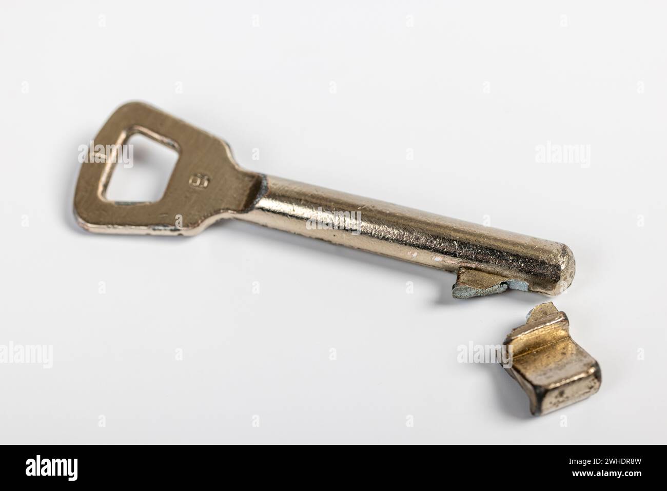 Broken room door key, colored bar key, white background, Stock Photo