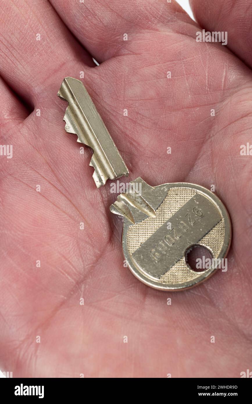 Broken apartment key on a man's palm, cylinder key Stock Photo Alamy