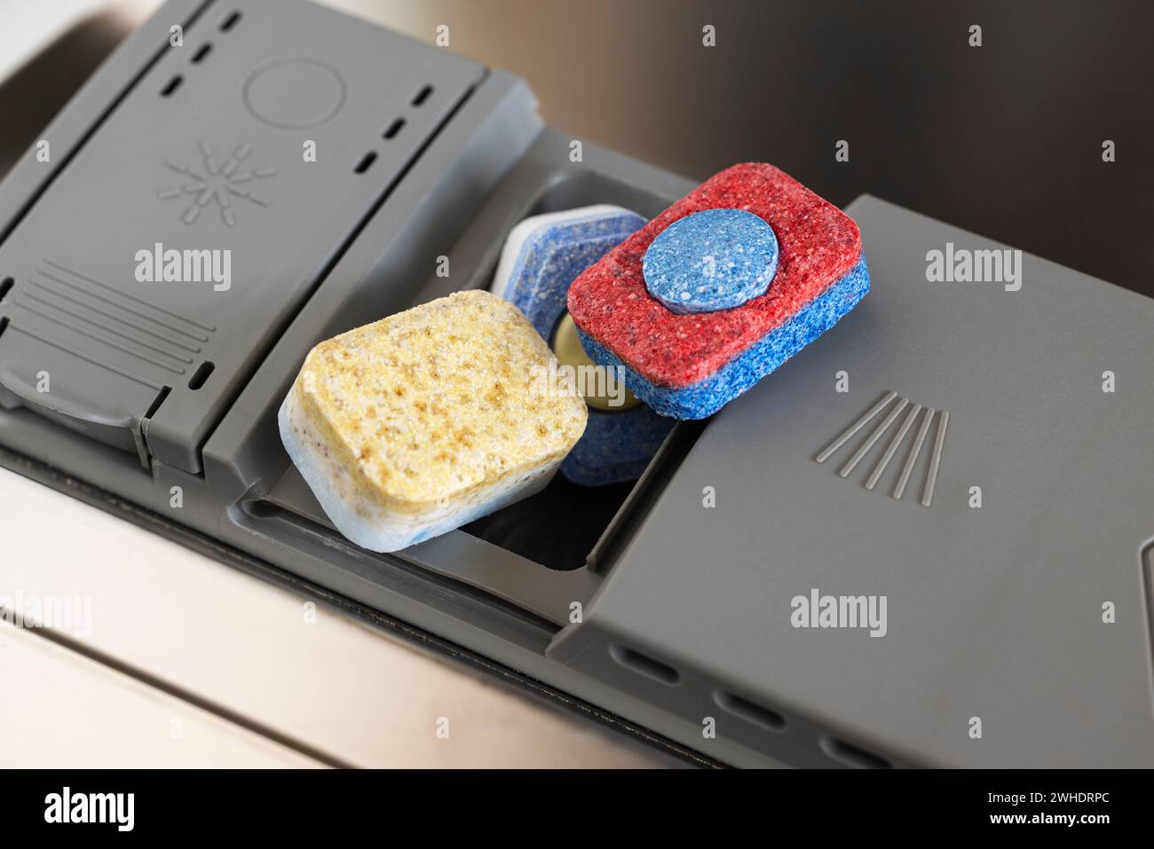 Dosing chamber with three cleaning tabs, various brands, detail