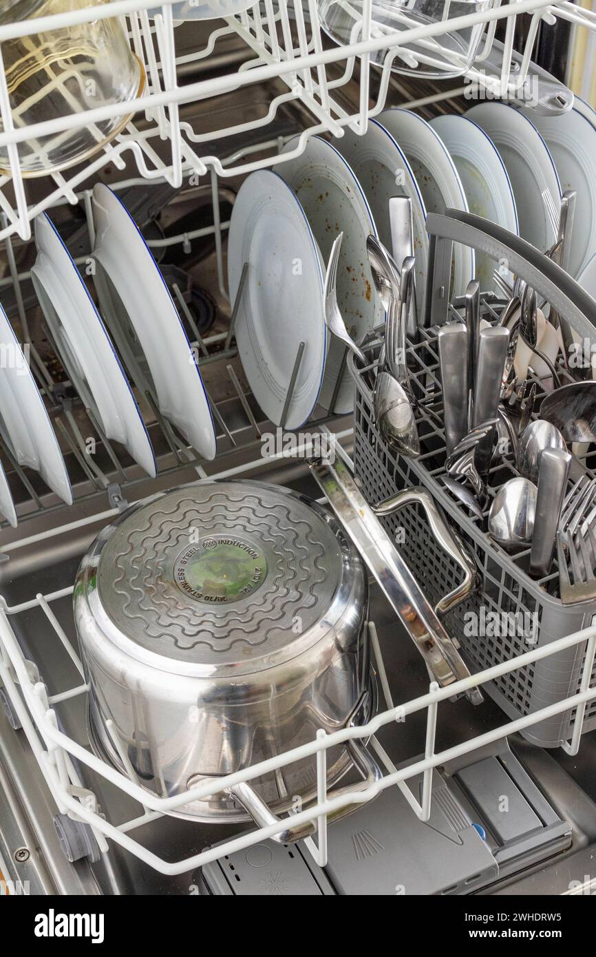 Filled dishwasher, clean dishes Stock Photo