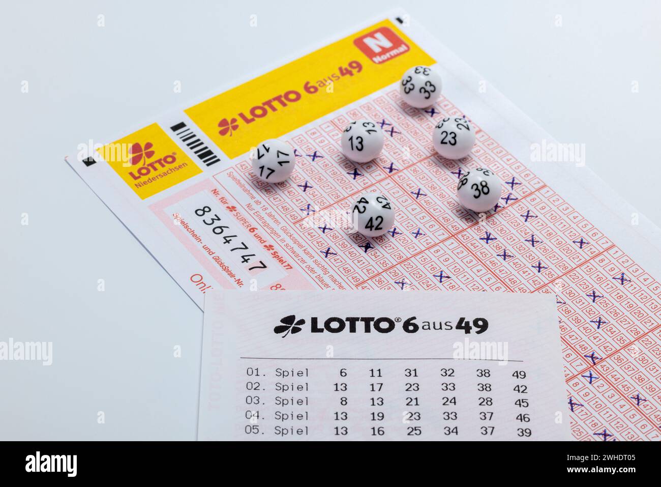Lotto balls lying on a completed lottery ticket, LOTTO 6aus49, receipt, white background, Stock Photo
