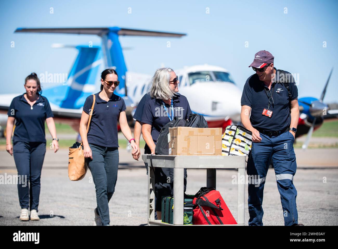 A Royal Flying Doctor Service (RFDS) crew walks across the tarmac at ...
