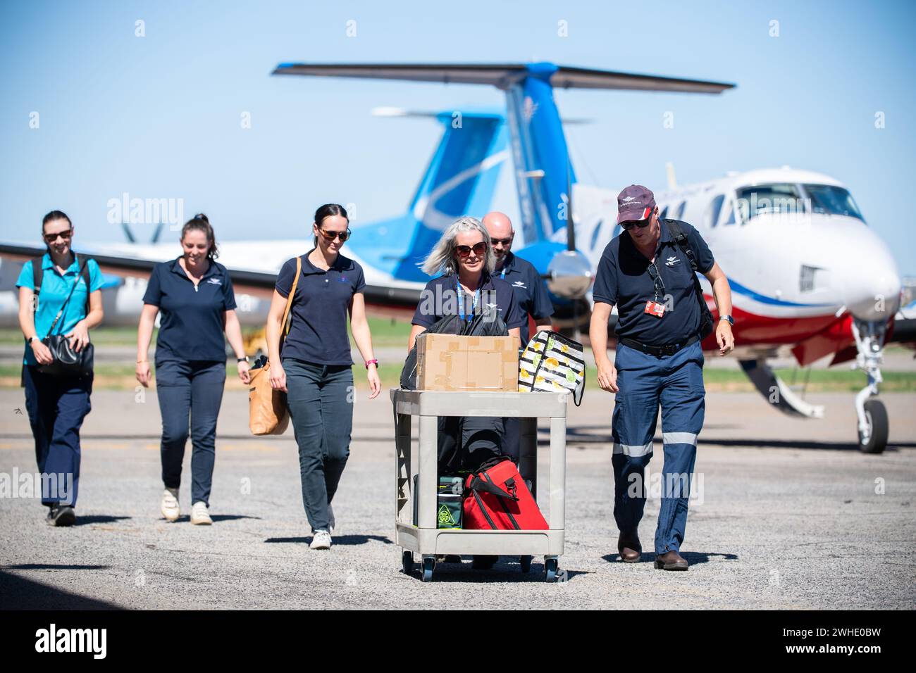 A Royal Flying Doctor Service (RFDS) crew walks across the tarmac at ...