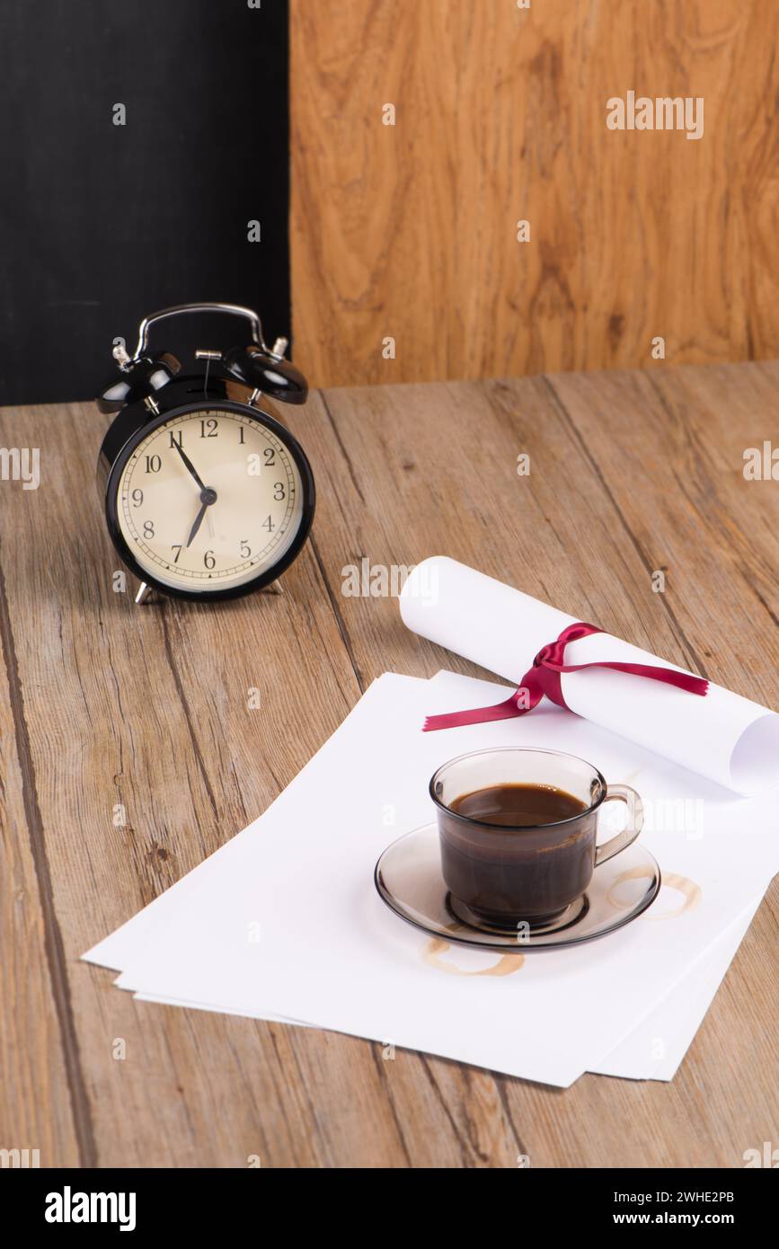 Old clock, hat, coffee and paper sheets Stock Photo
