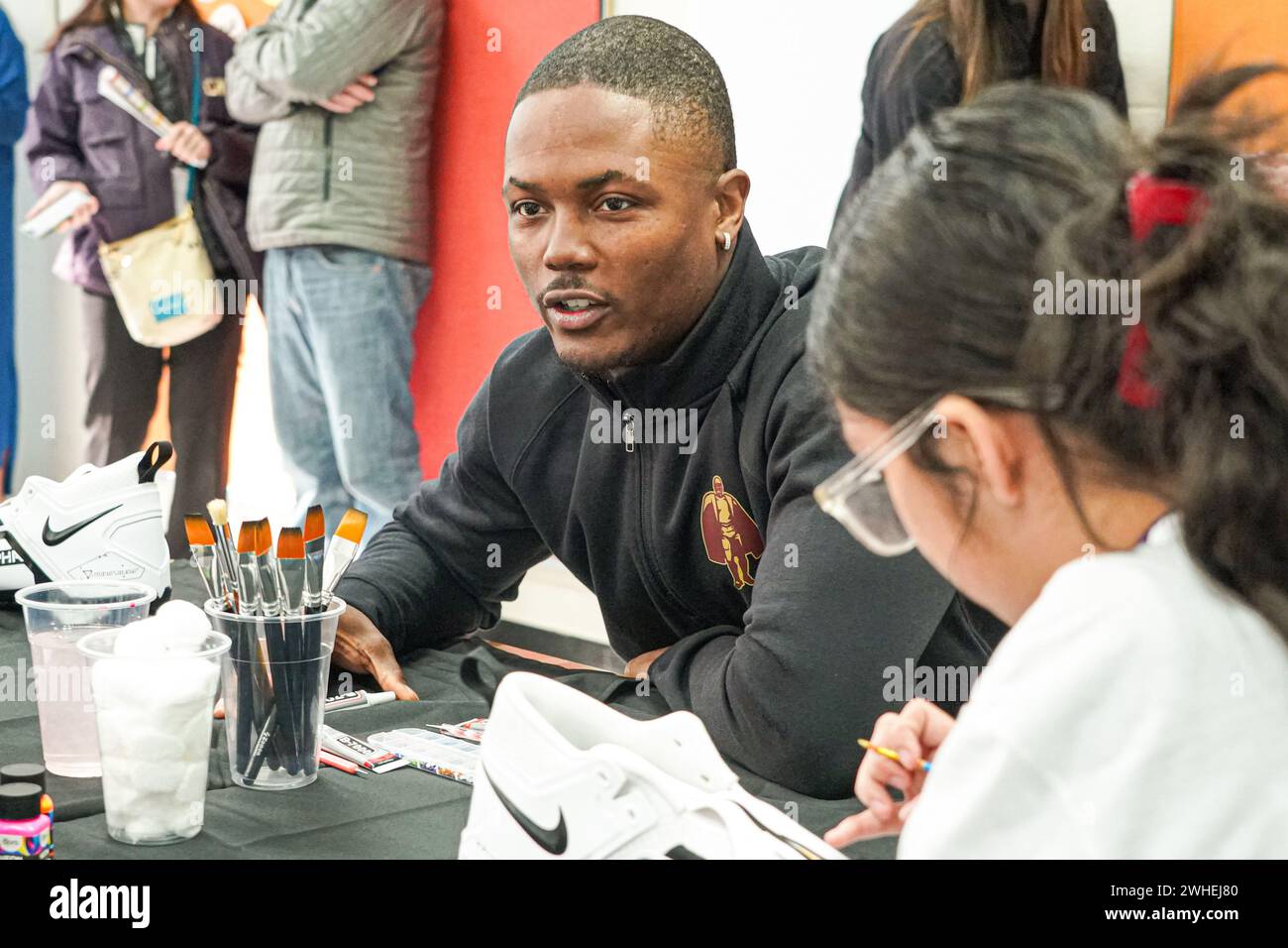 Henderson, Nevada, USA, February 9, 2024, Terry McLaurin painting cleats with some of the kids during the Walter Payton NFL Man of the Year Event At the Donald W. Reynolds Boys & Girls Club (Photo Credit: Marty Jean-Louis/Alamy Live News Stock Photo