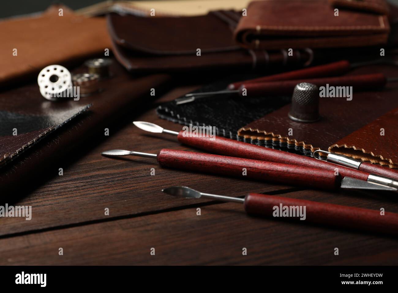 Leather samples and tools on wooden table Stock Photo