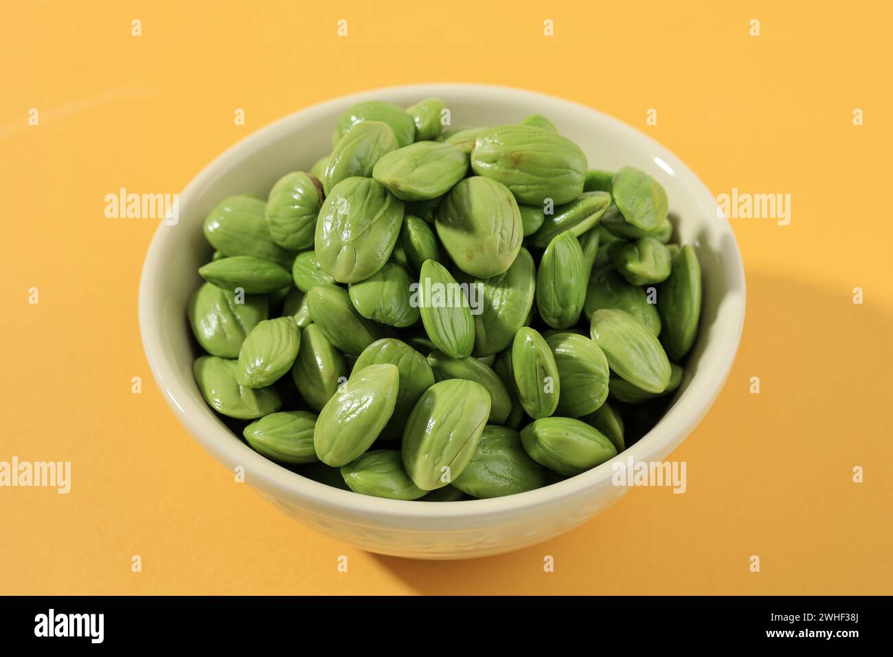 Petai Kupas Raw Green Stinky Bean on Ceramic Bowl Stock Photo
