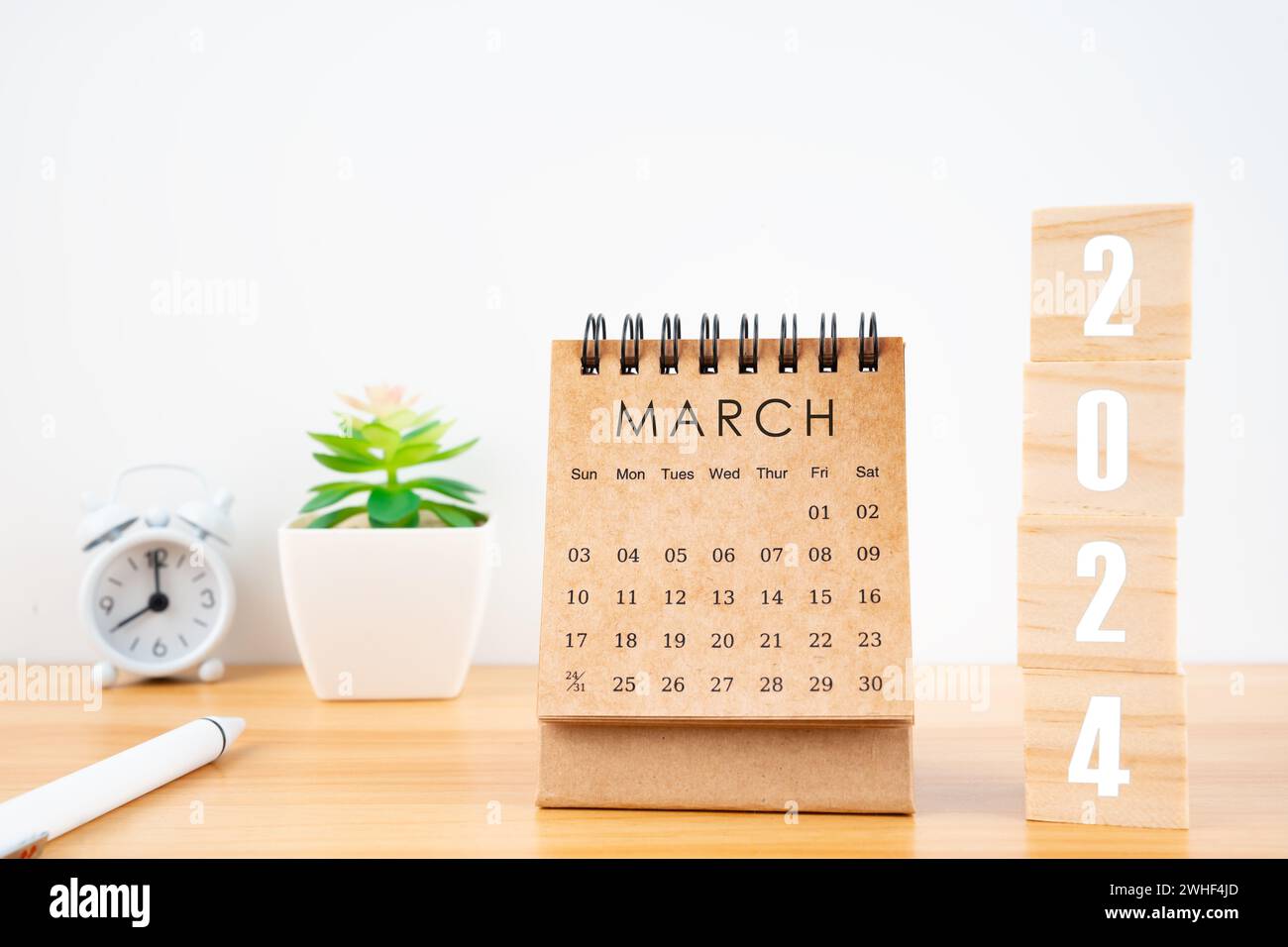March 2024 desk calendar with wooden cubes show 2024 number on ...