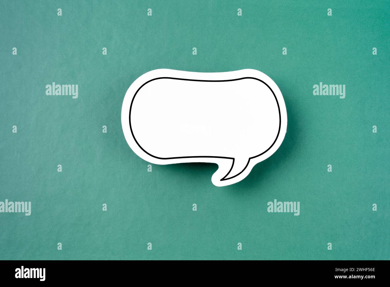 White empty speech bubble on green color background Stock Photo - Alamy