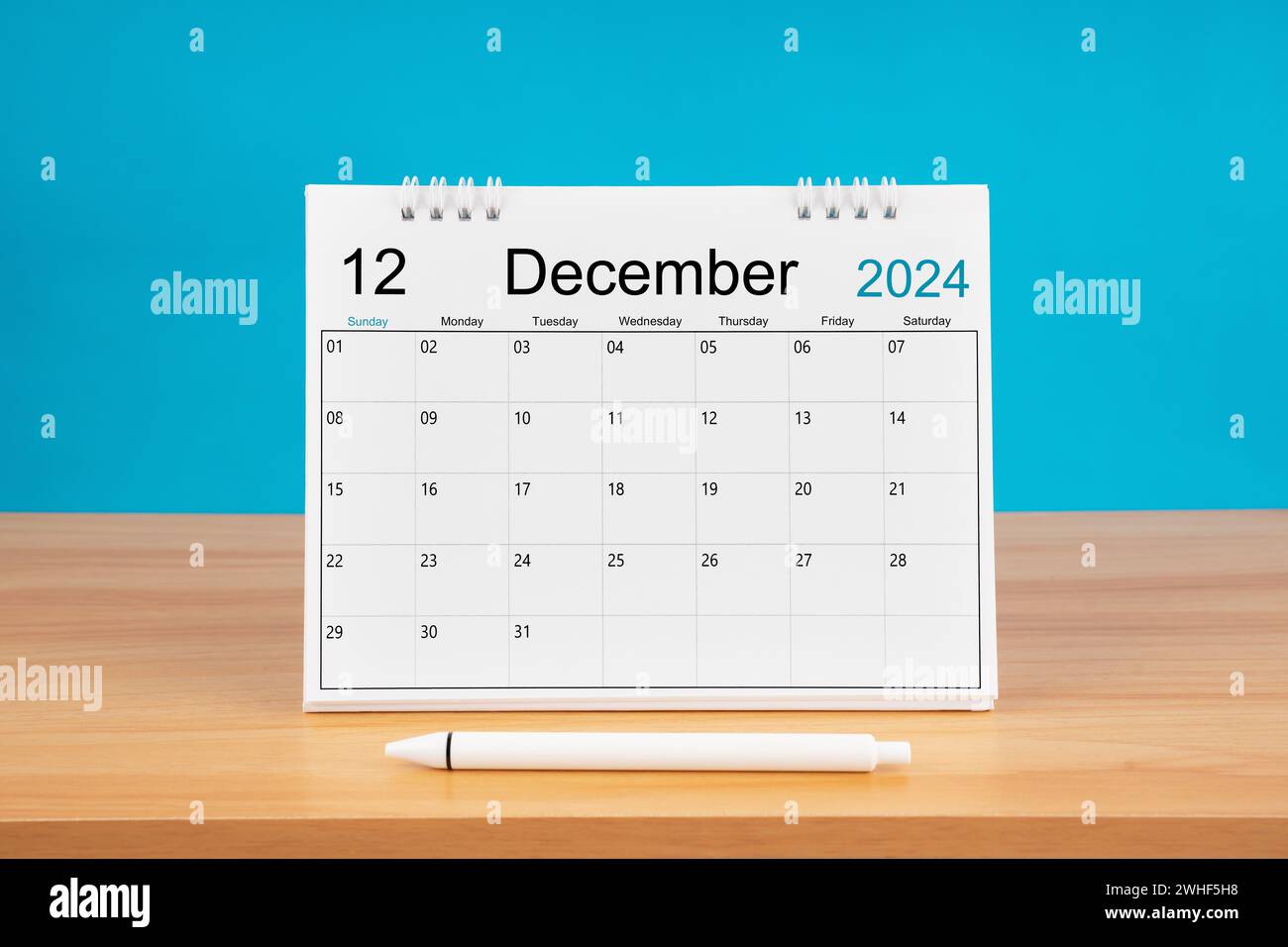 December monthly desk calendar for 2024 year and pen on wooden table ...