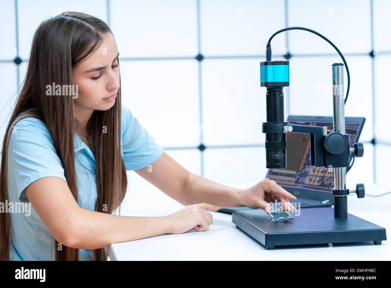 Scientist testing microelectronic device Stock Photo