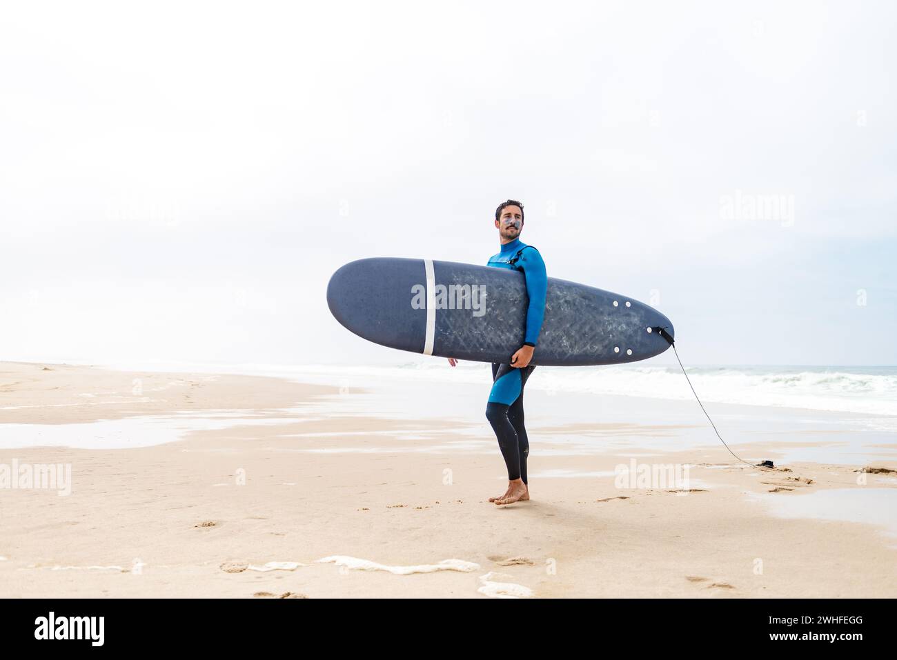 Male surfer wearing board hi-res stock photography and images - Alamy
