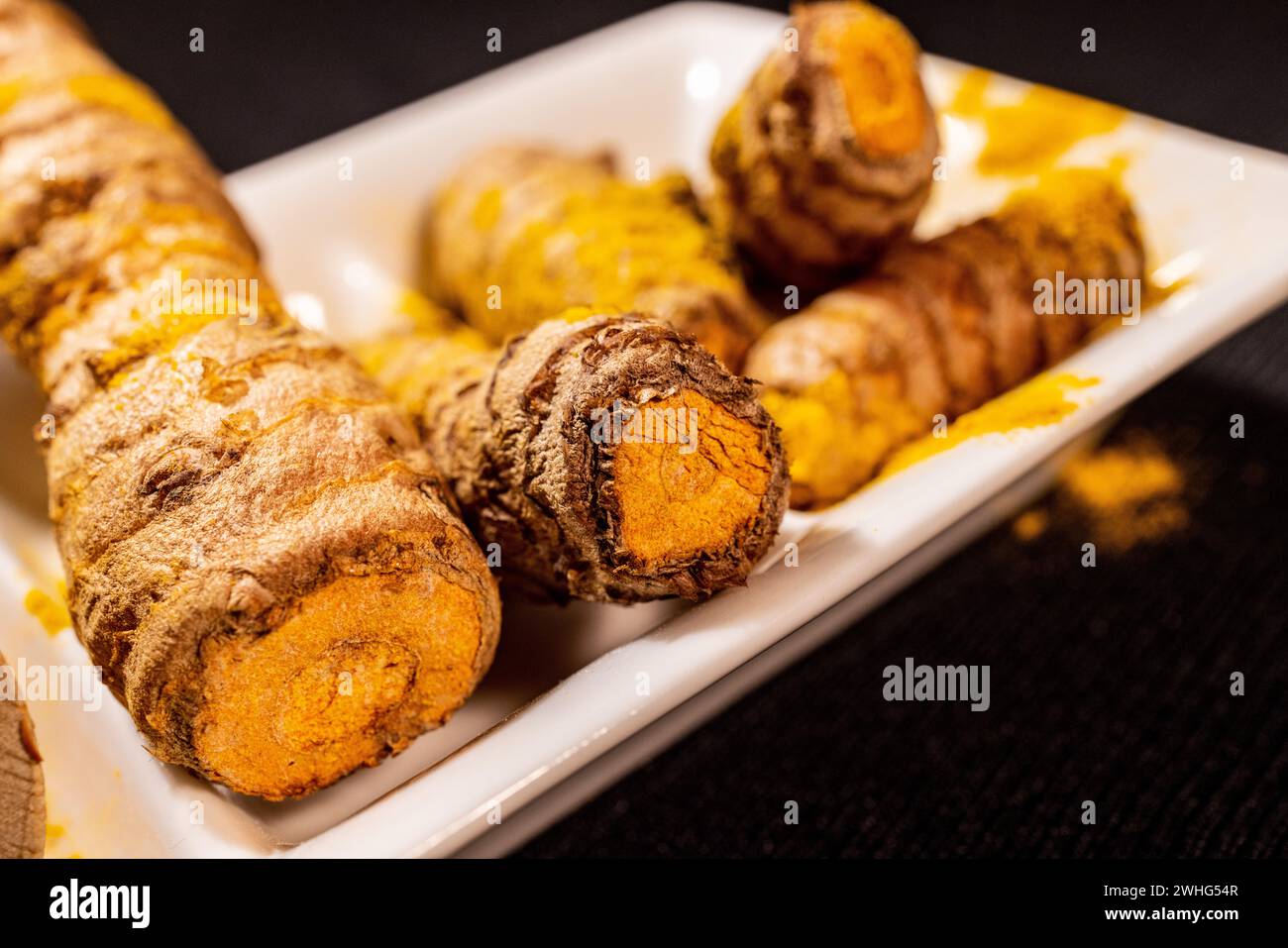 Ginger Roots on a dark background. Stock Photo