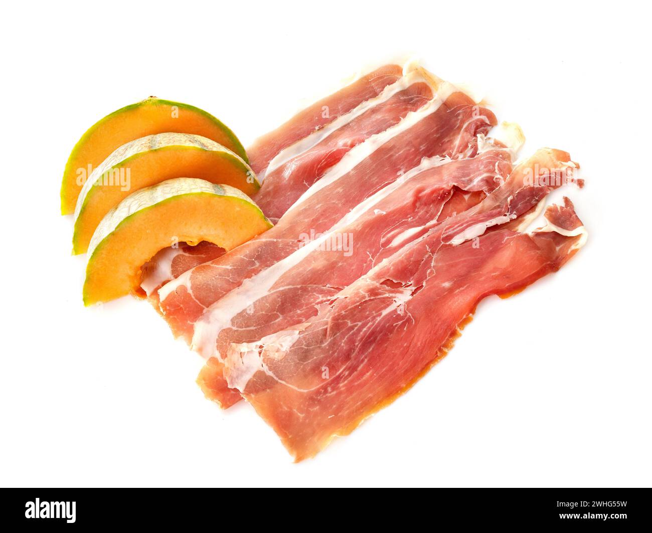 slice of cured ham serano and melon in front of white background Stock Photo