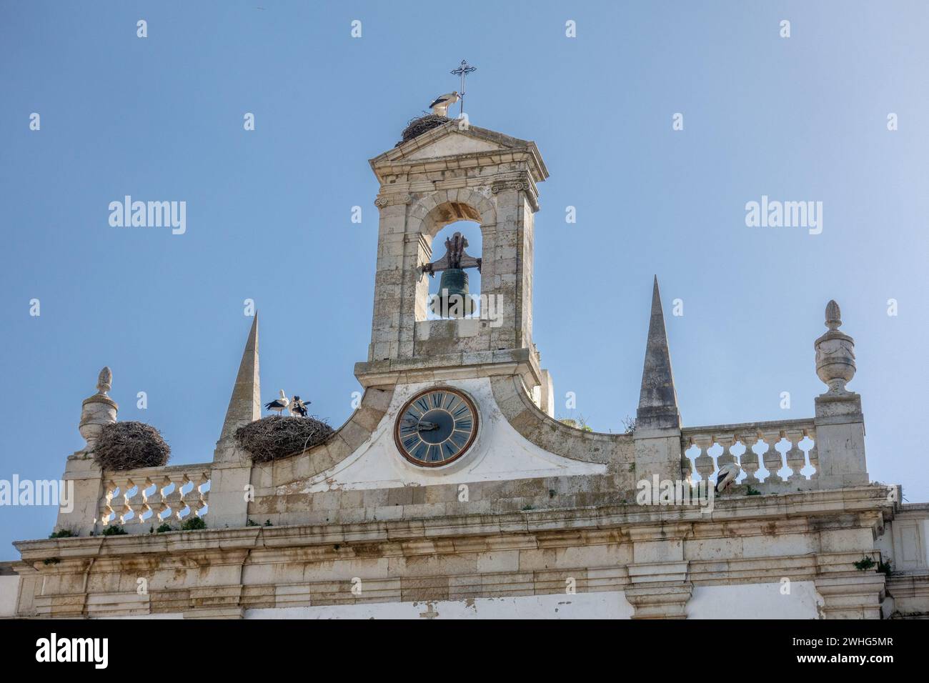 The Town Arch (Arco da Vila), In Faro With Nesting White Storks (Ciconia ciconia)  In Downtown Faro The Algarve Portugal, February 6, 2024 Stock Photo