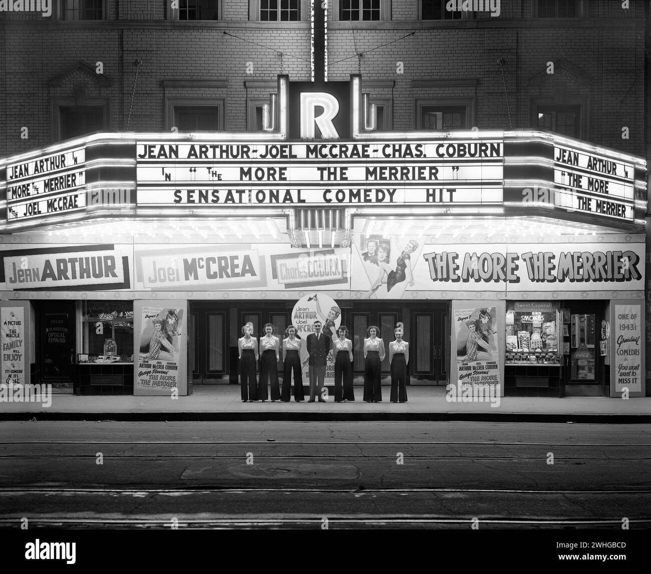 Vintage photo of the Rialto Theatre, Edmonton, showing 'The More the Merrier' in bold letter on lit up Marquee. circa 1940s Stock Photo