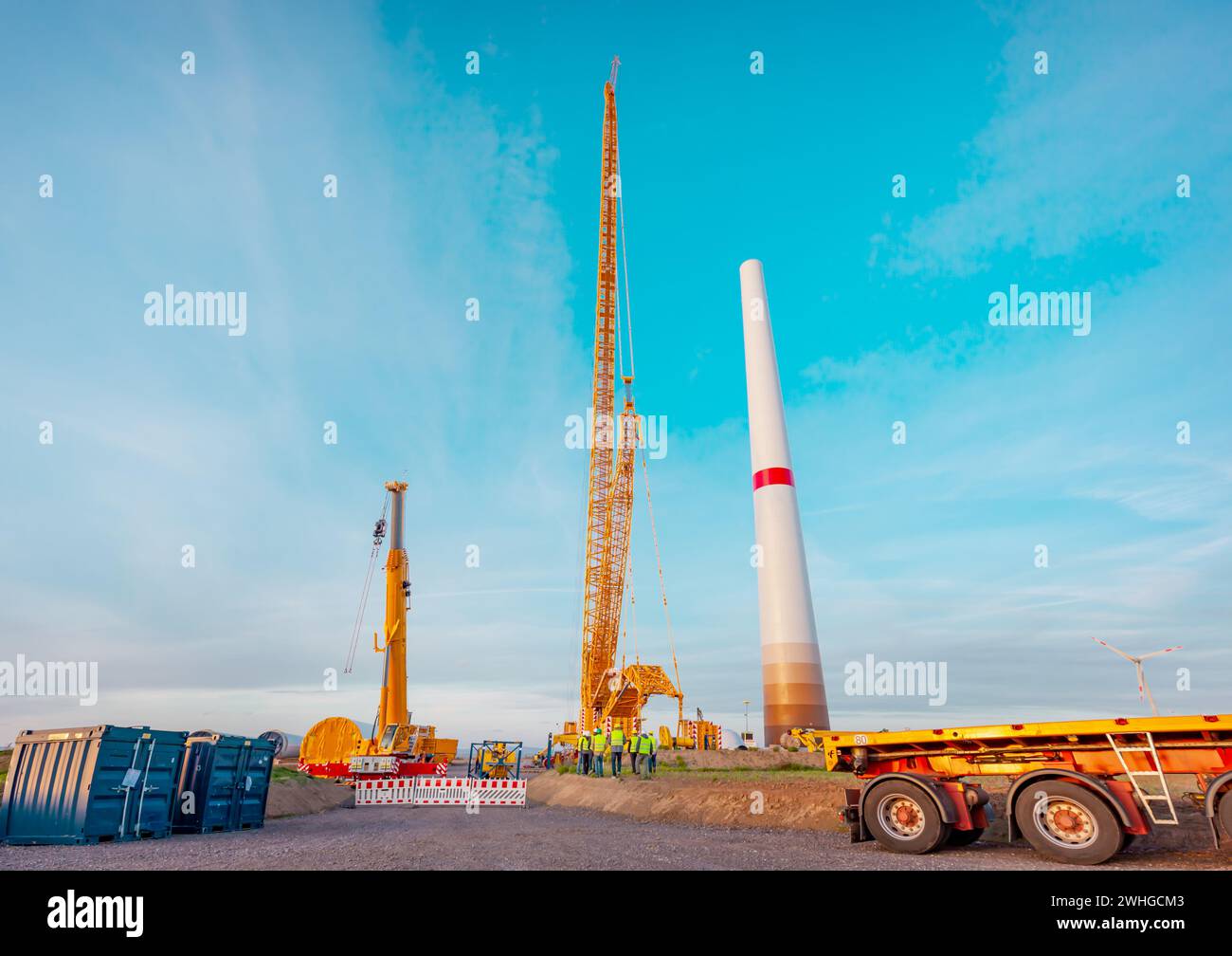 Building and assembling a construction windturbine by Crawler Track Crane - machinery. Stock Photo