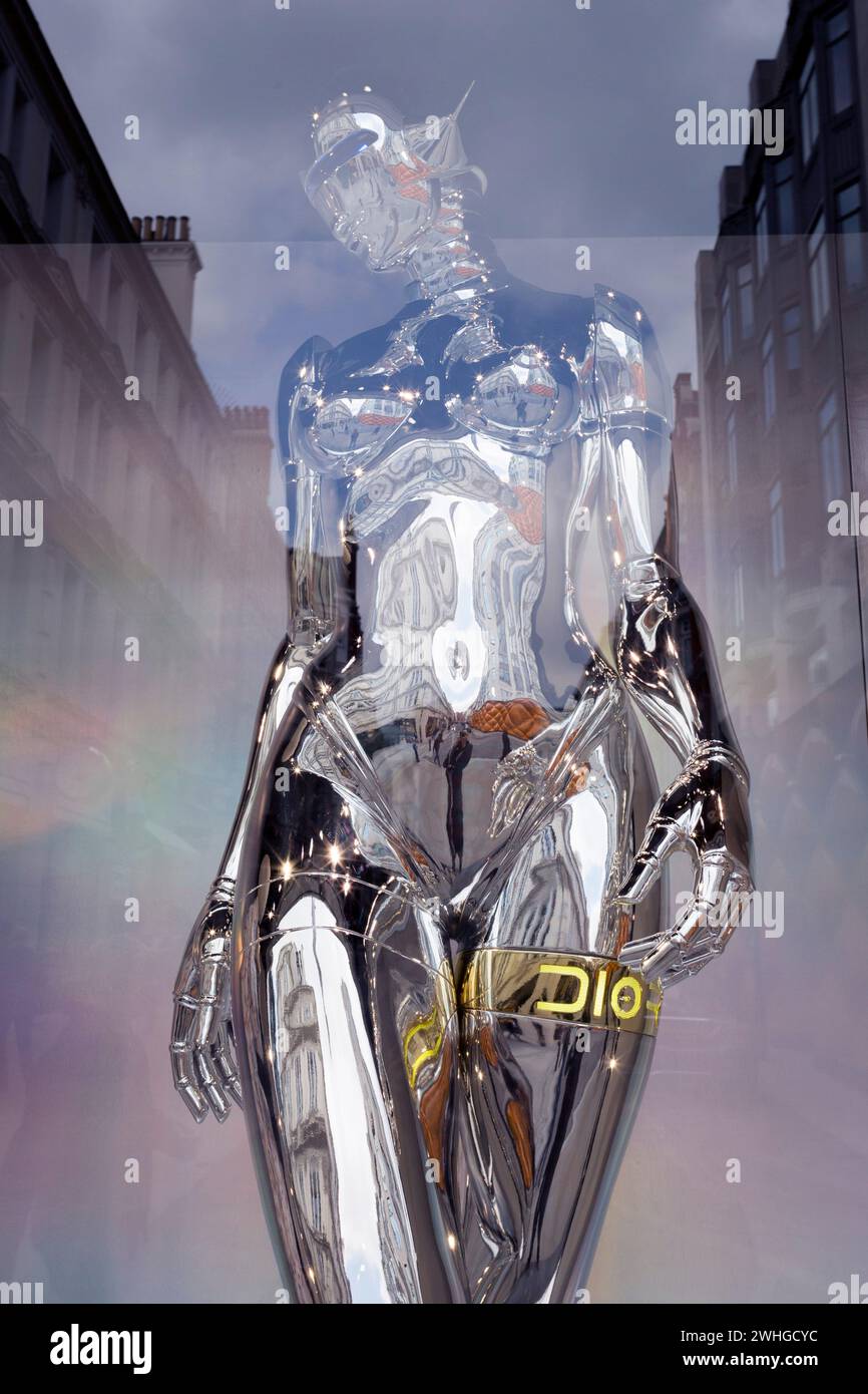 A highly-reflective silver-coloured mannequin in the window of the fashion brand Dior in New Bond Street, on 30th April 2019, in London, England Stock Photo