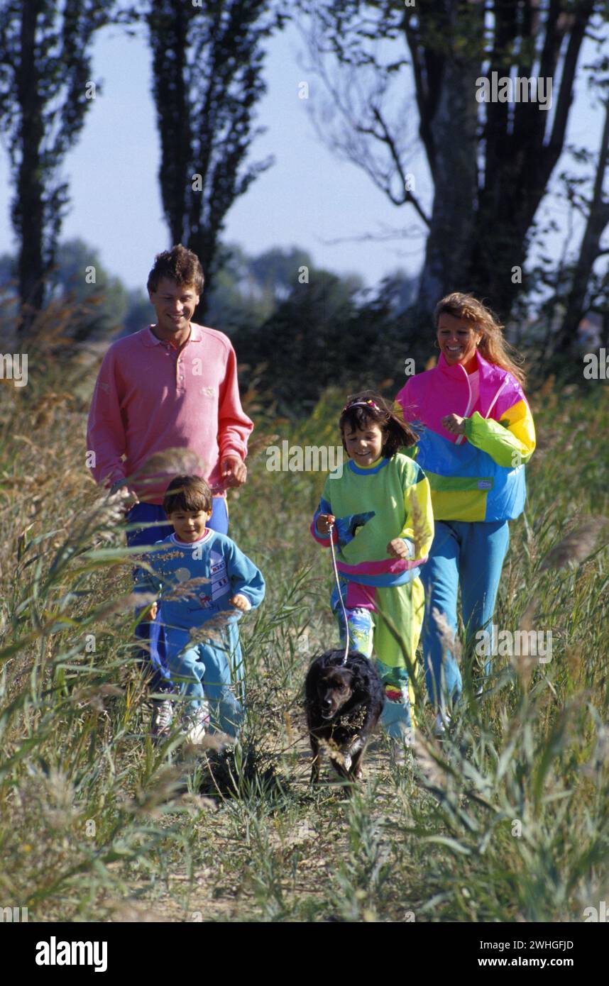 young family walking in country green grass allround Stock Photo