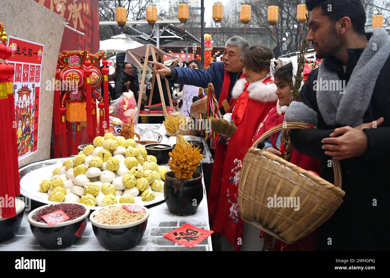 Beijing, China's Shaanxi Province. 2nd Feb, 2024. Foreign students learn about folk customs of the Kitchen God Festival, also known as the Little New Year on the Chinese lunar calendar, in the Yongxingfang cultural block in Xi'an, northwest China's Shaanxi Province, Feb. 2, 2024. Credit: Liu Xiao/Xinhua/Alamy Live News Stock Photo