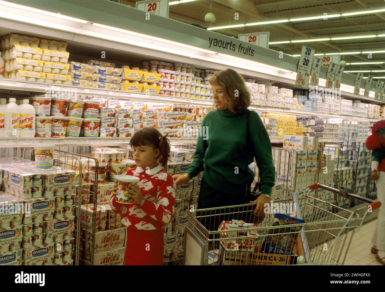 mother and her little girl shopping on supermarket in frontmilk products line france Stock Photo