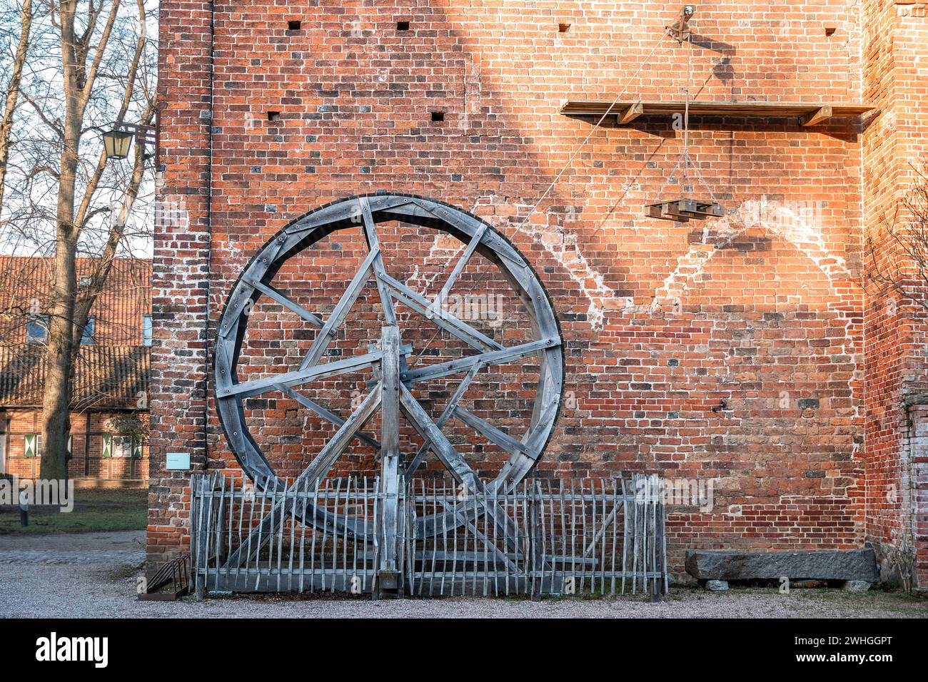 Historic treadwheel crane with pulley, plank scaffold and a hanging pallet for heavy charge as demonstration of medieval constru Stock Photo