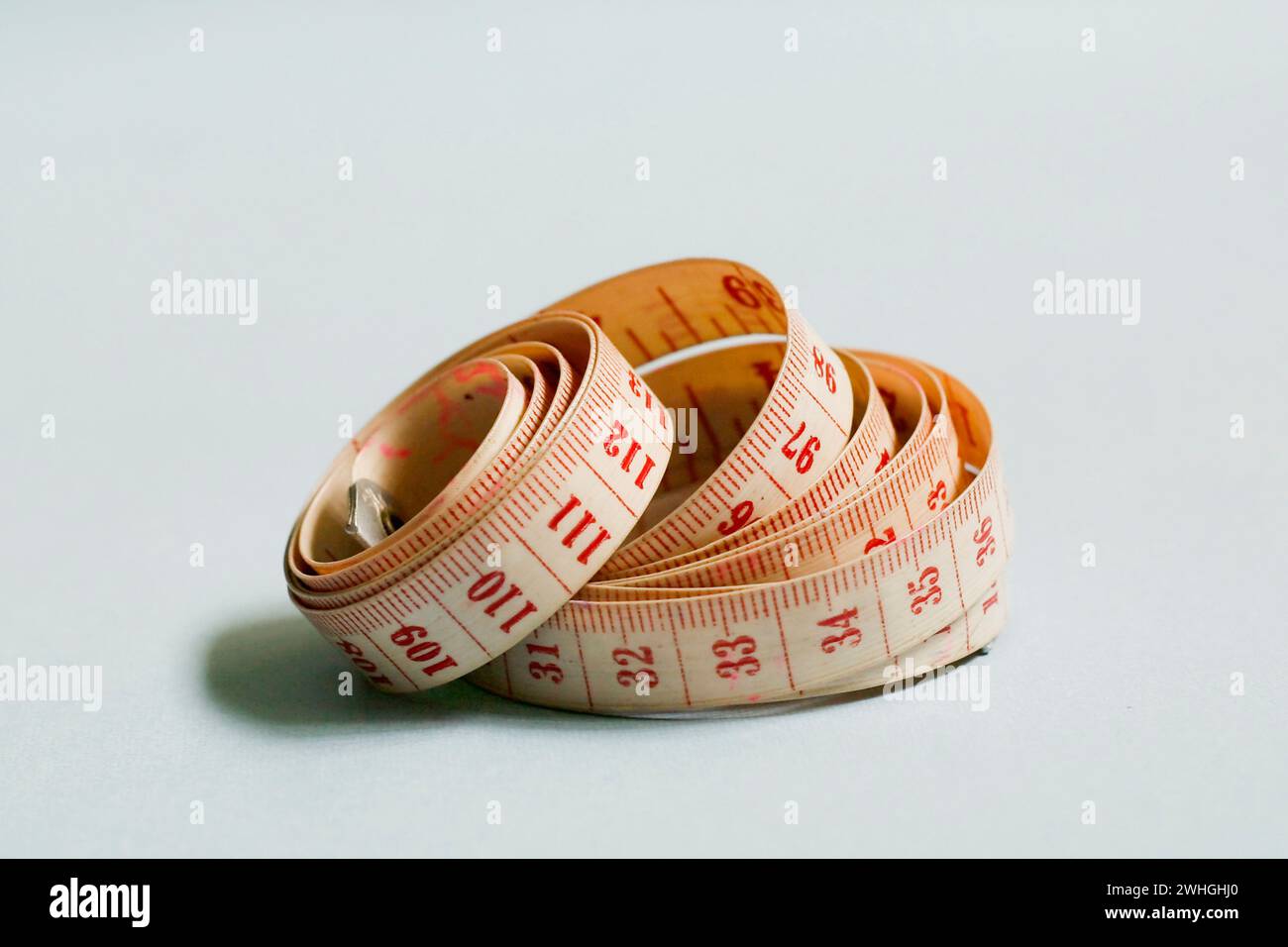 Tape Measure isolated on blue background Stock Photo