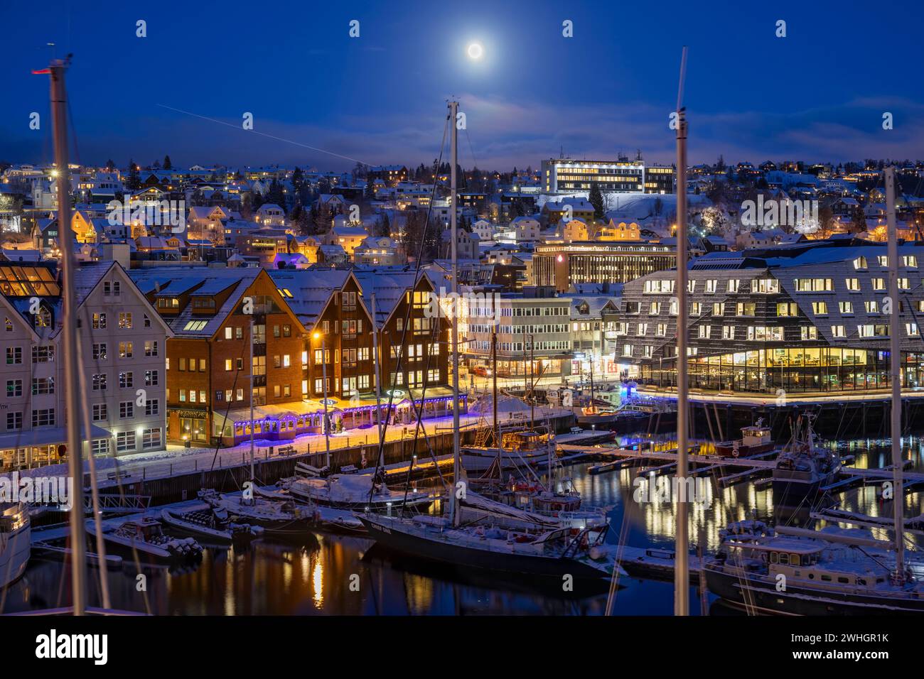 Europe, Norway, Tromso Harbour at Night with moored Boats in the Wintertime Stock Photo