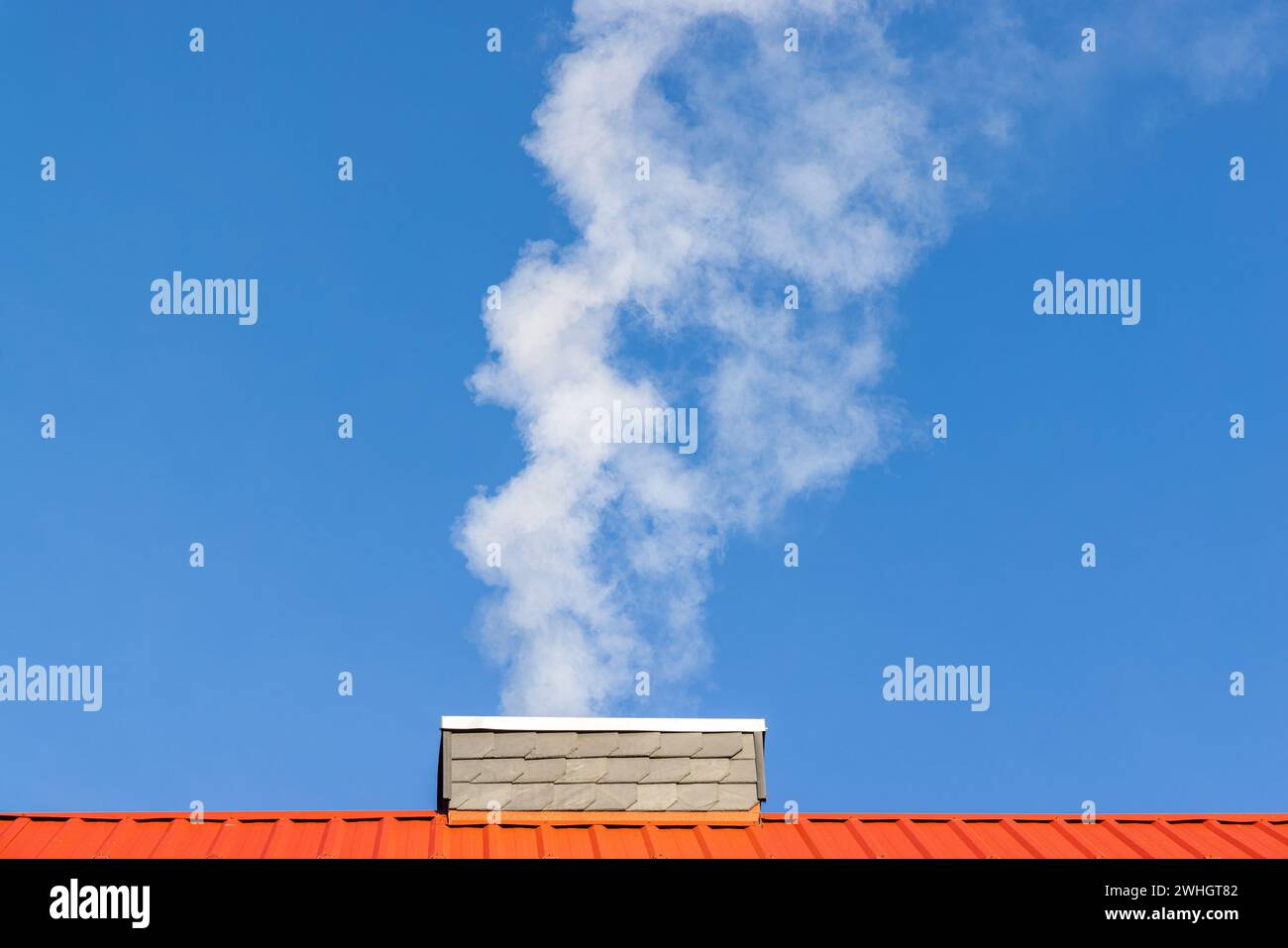 Heating with fossil fuels Smoking chimney Stock Photo