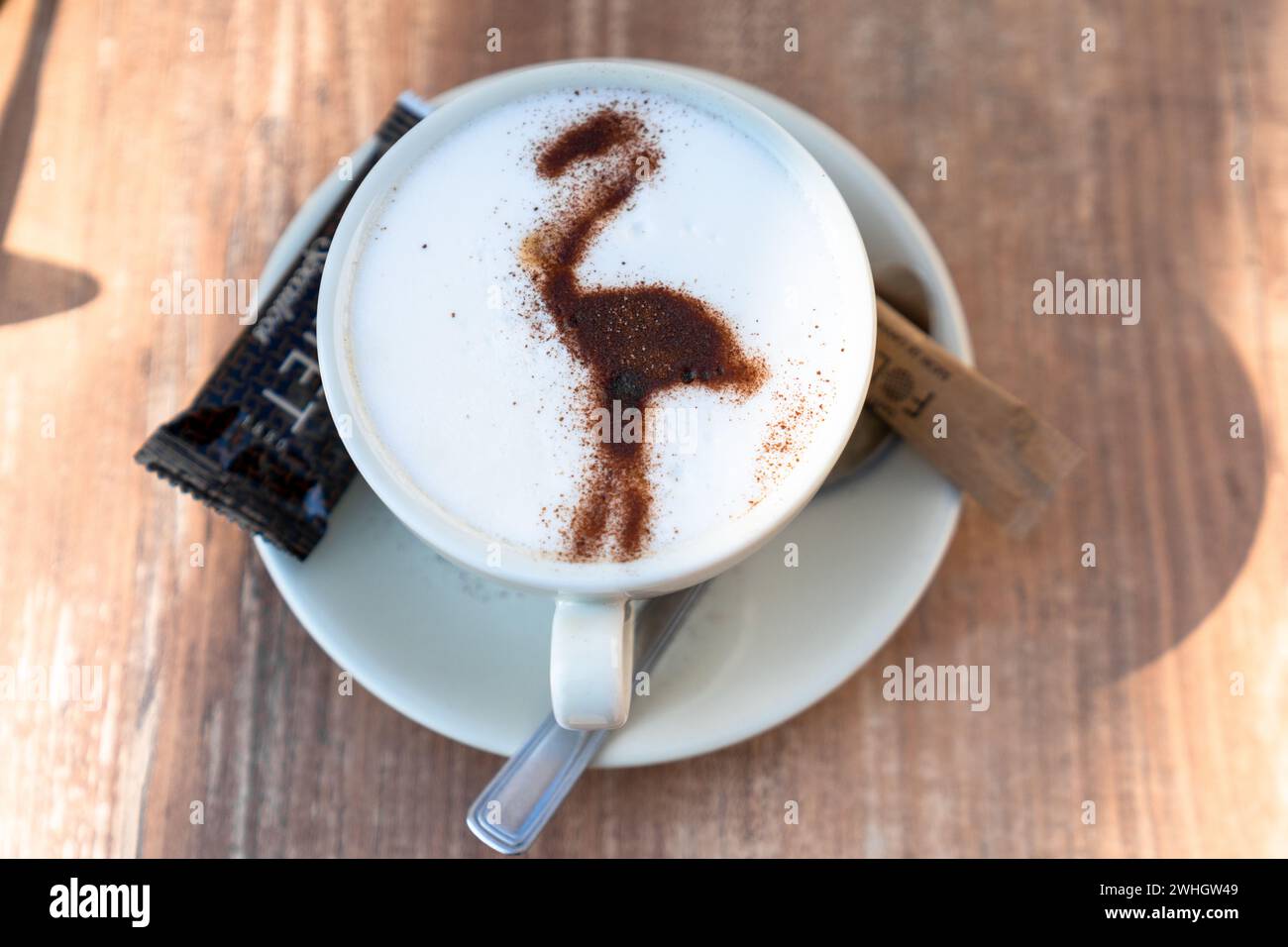 Close-up view of a delicious coffee with milk and a Camargue flamingo in chocolate powder Stock Photo