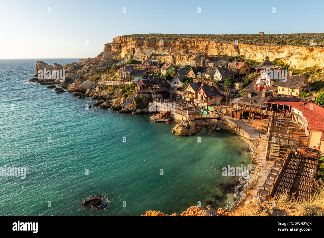 Il-Mellieha, Malta - Panoramic skyline view of the famous Popeye Village at Anchor Bay at sunset Stock Photo