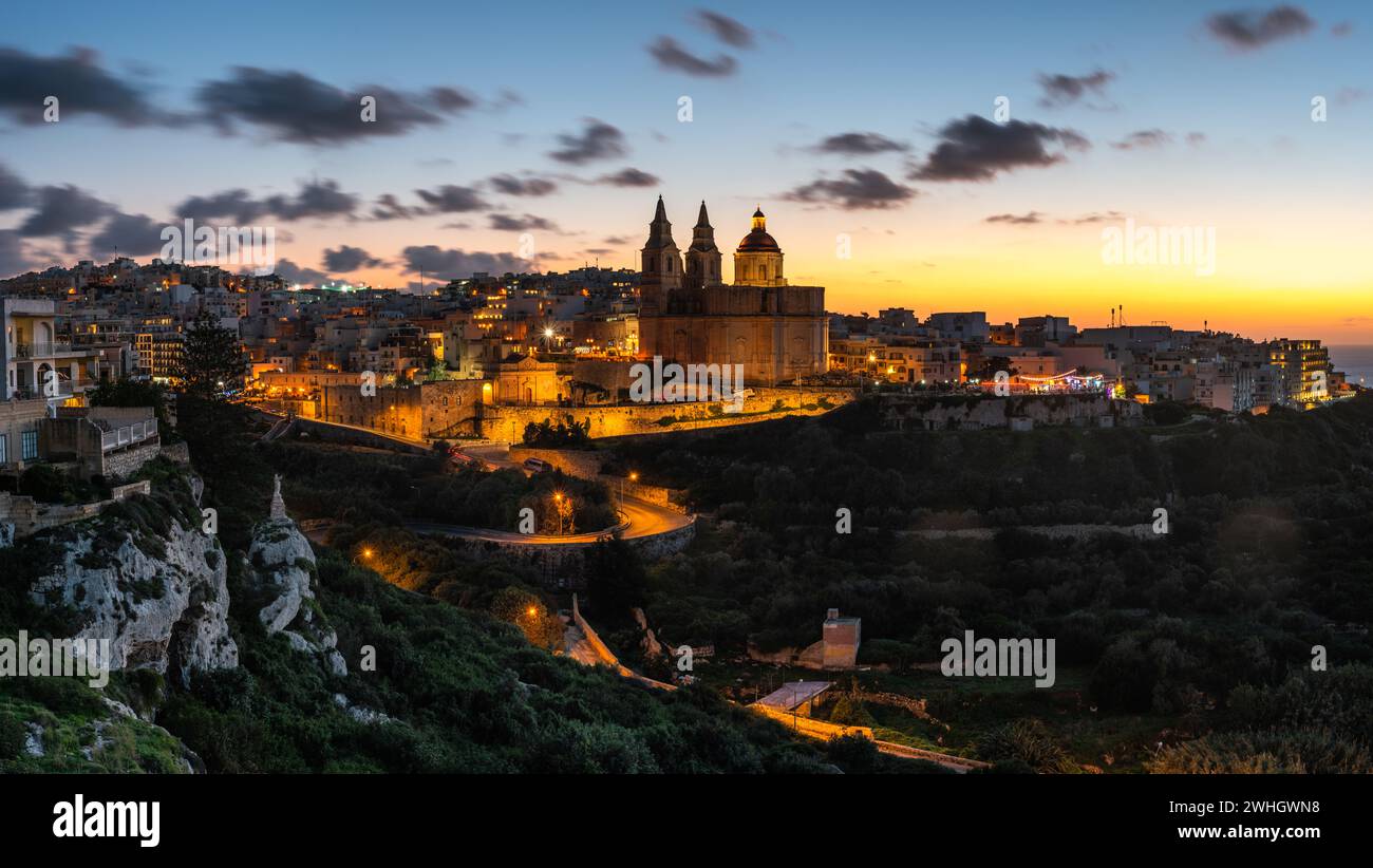 Il-Mellieha, Malta - Beautiful panoramic skyline view of Mellieha town after sunset with Paris Church Stock Photo