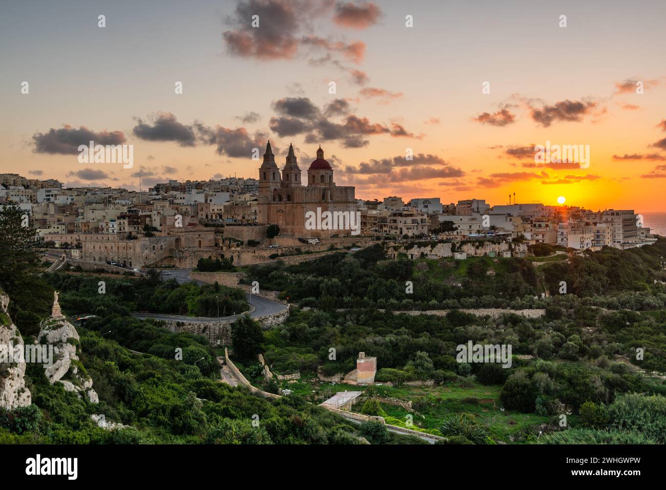 Il-Mellieha, Malta - skyline view of Mellieha town at sunset with Paris Church on hill top Stock Photo