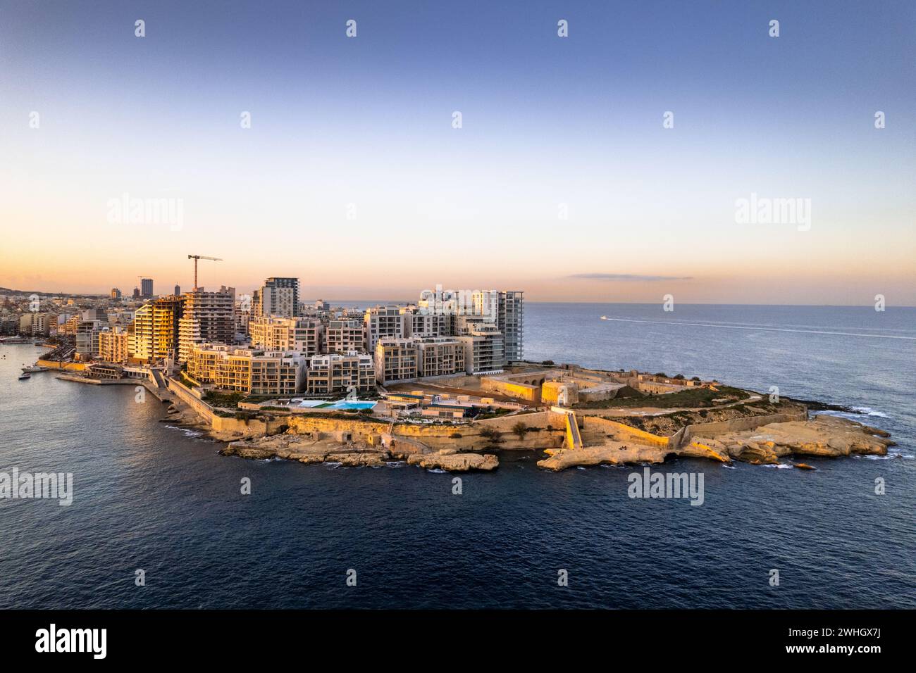 Aerial view of Sliema in Malta, skyline at sunset, blue sea waters and sky. Aerial drone view Stock Photo