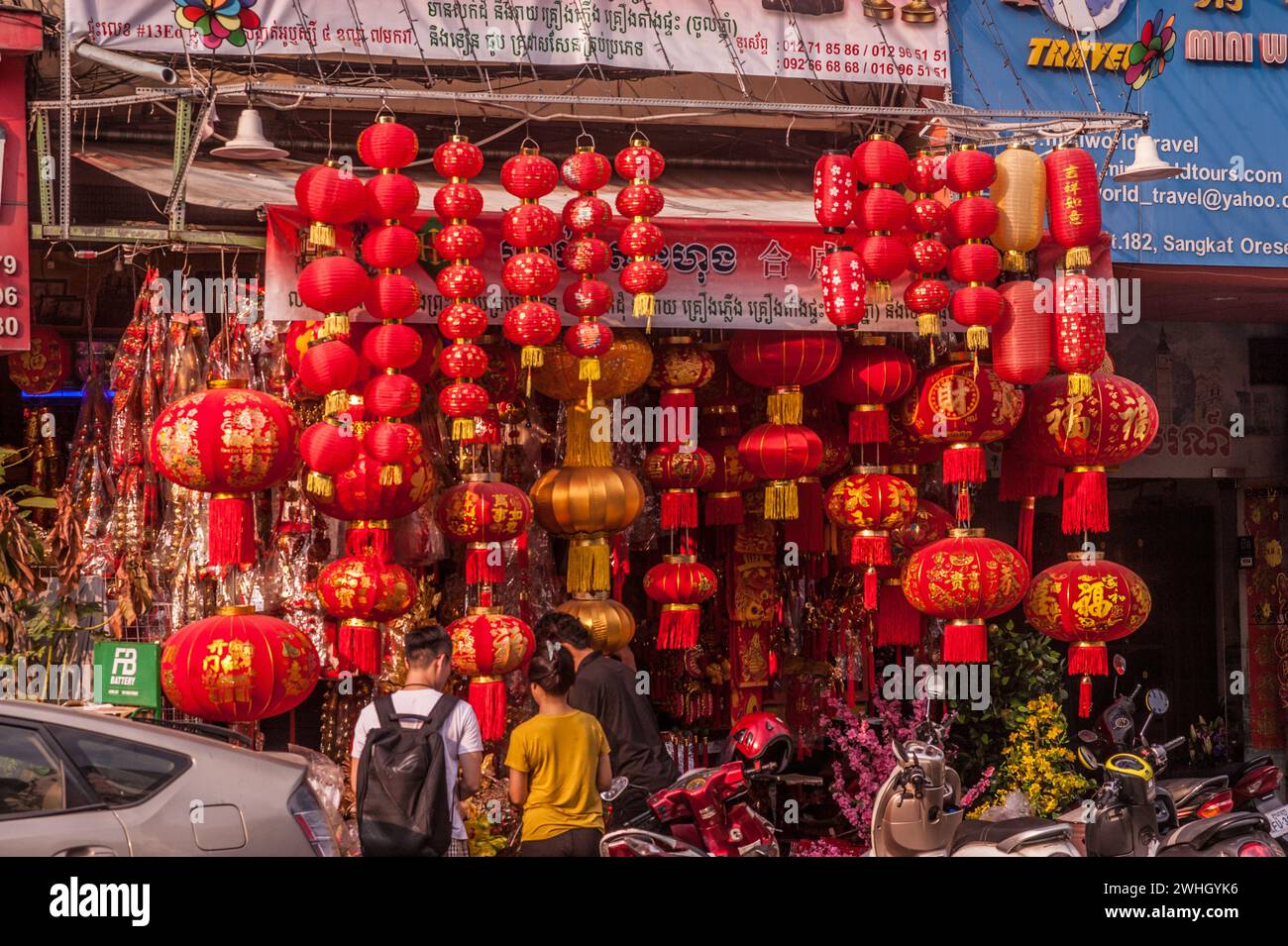 Cambodian couple shopping for Chinese New Year decorations, Year of the Dragon. Orussey Market, Phnom Penh, Cambodia. Feb. 9th, 2024. © Kraig Lieb Stock Photo