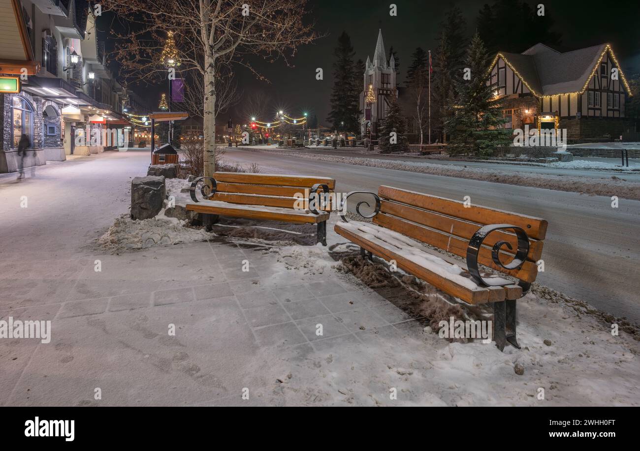 Night view of Benches on Banff Avenue in the town of Banff, Alberta, Canada Stock Photo