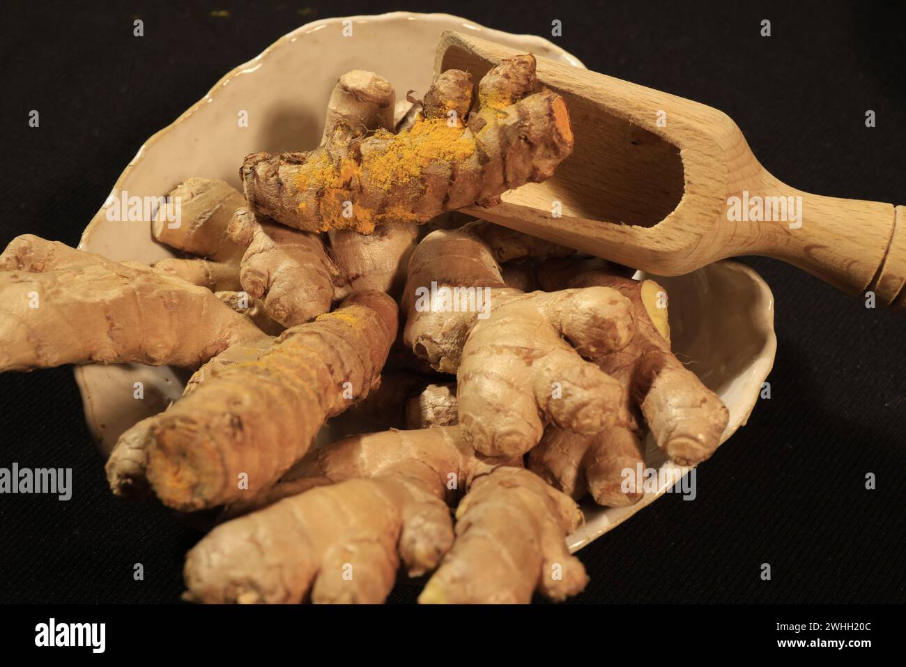 Ginger Roots on a dark background. Stock Photo