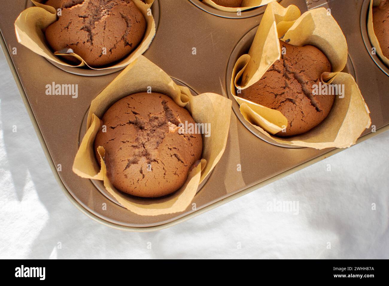 Chocolate cake batter in a paper wrapper in a baking dish Stock Photo ...