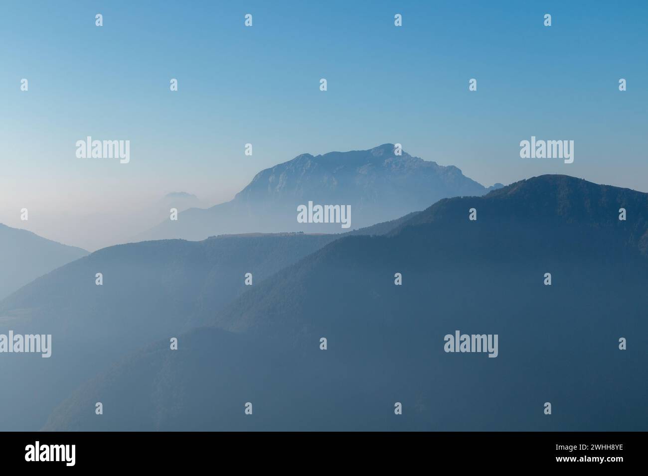 Spectacular mountain ranges silhouettes in morning. Stock Photo