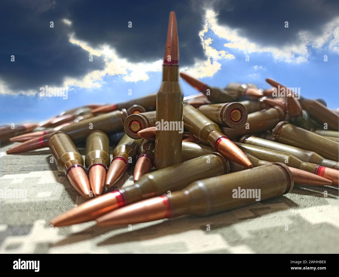 Cartridges for the Kalashnikov assault rifle. War concept. Pile of cartridges with bullets. pile of Stock Photo