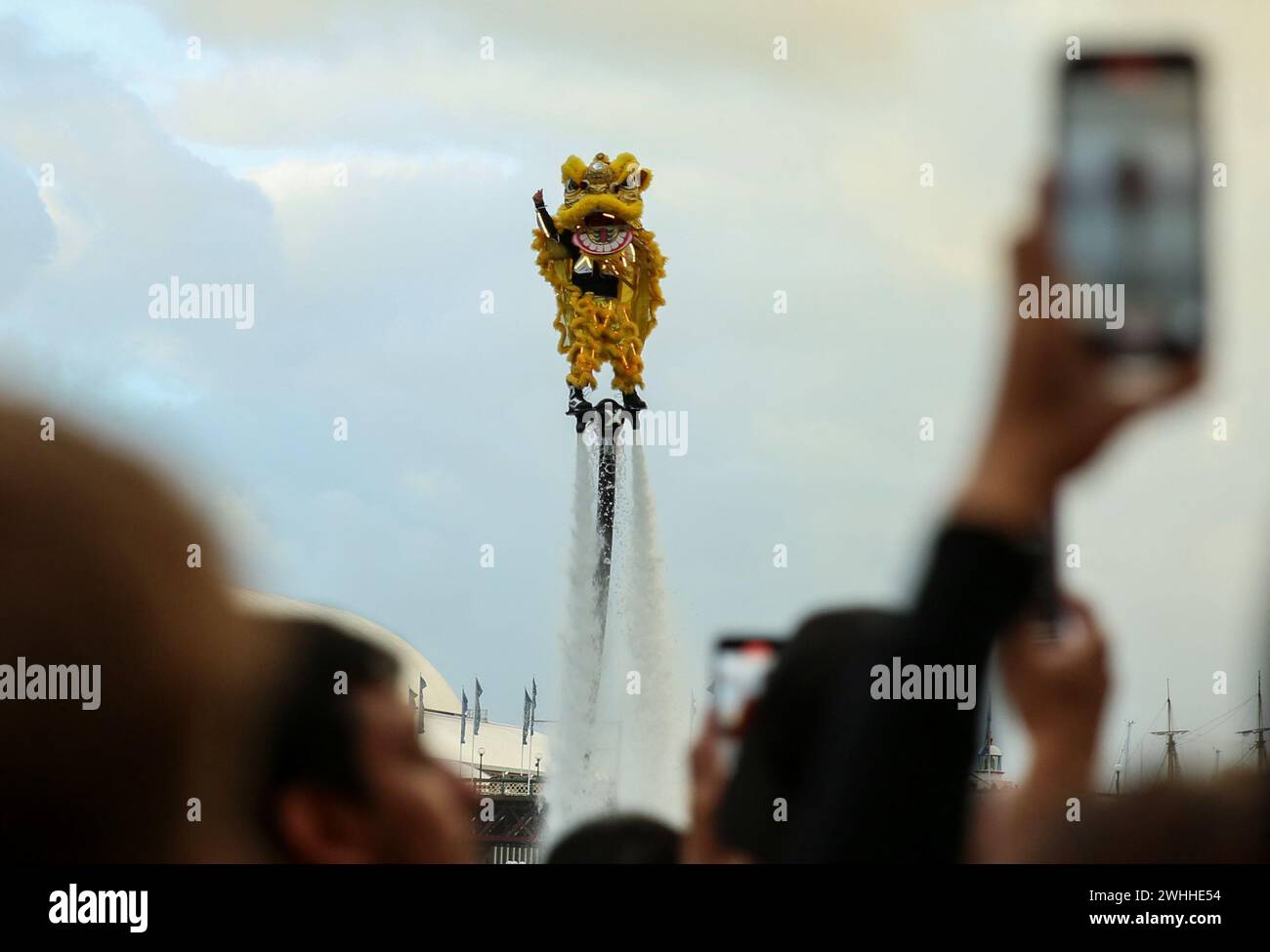 Sydney, Australia. 10th Feb, 2024. People watch a jet pack show themed on lion dance during the Chinese Lunar New Year celebration at the Darling Harbor in Sydney, Australia, Feb. 10, 2024. Credit: Ma Ping/Xinhua/Alamy Live News Stock Photo