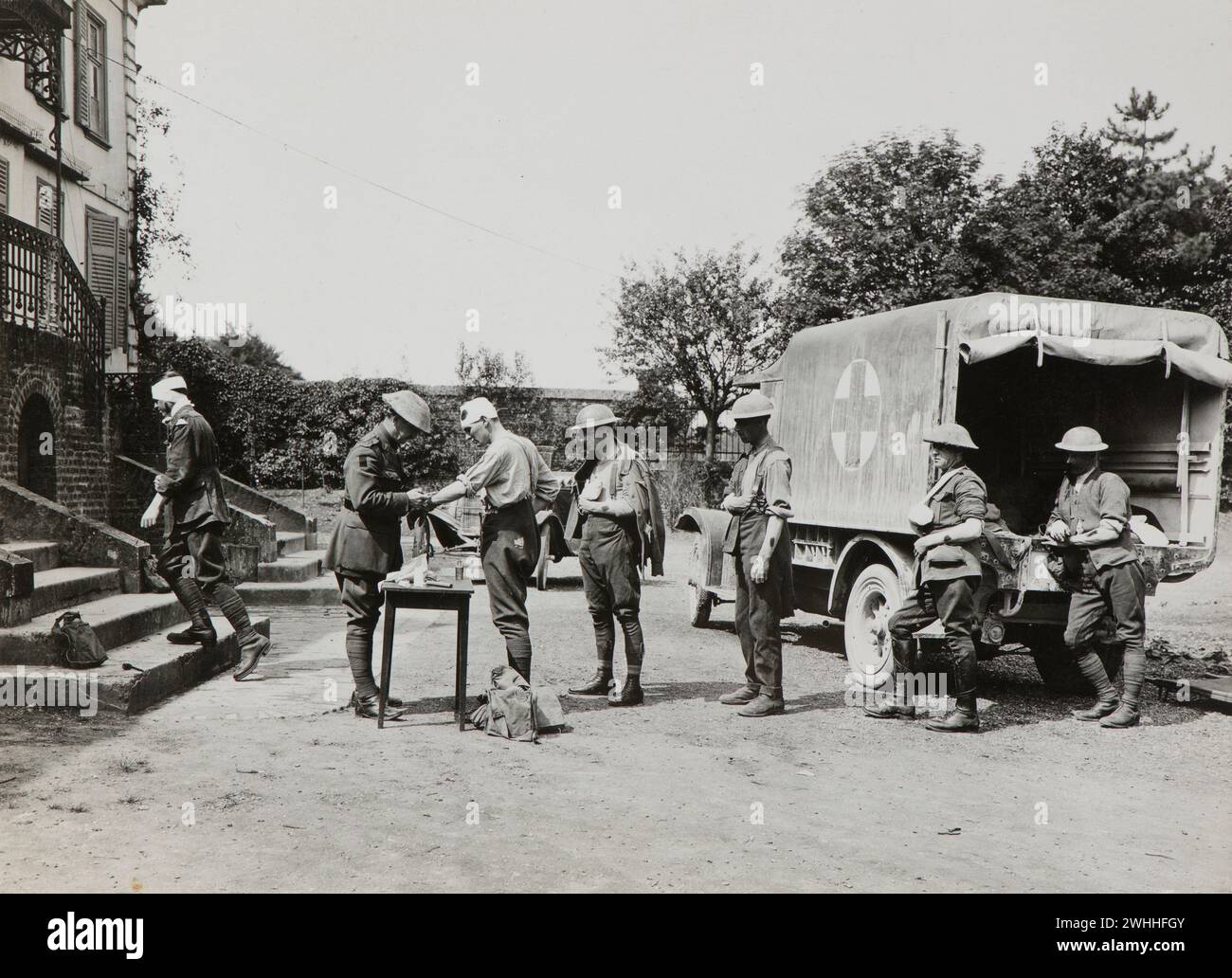 Villers-Bretonneux, France: Medics tending to wounded soldiers coming off ambulance to proceed inside the Red Chateau.  Photographs of the 8th Field Ambulance, Australian Imperial Force in France ca 1917-1918 Stock Photo