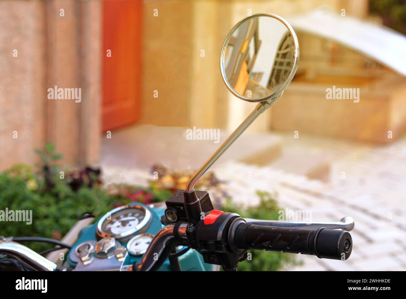 Moped mirror. City on sunny day. Ride for relaxation. Active life concept. Stock Photo