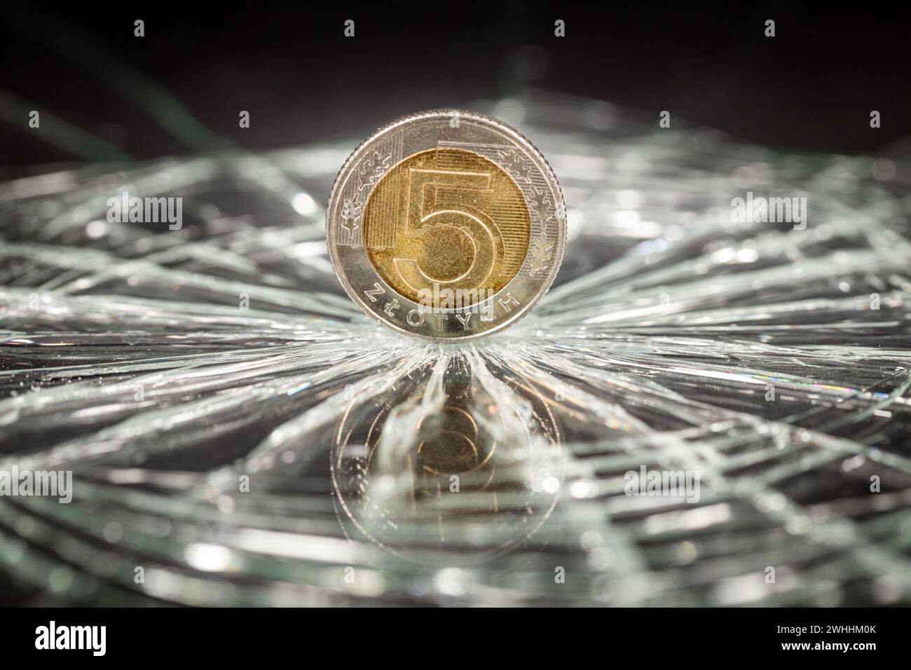 Poland money, Coin of 5 Polish zlotys reflecting in broken glass, Financial concept, Polish currency, Exchange rate drop, analyzes and forecasts for P Stock Photo