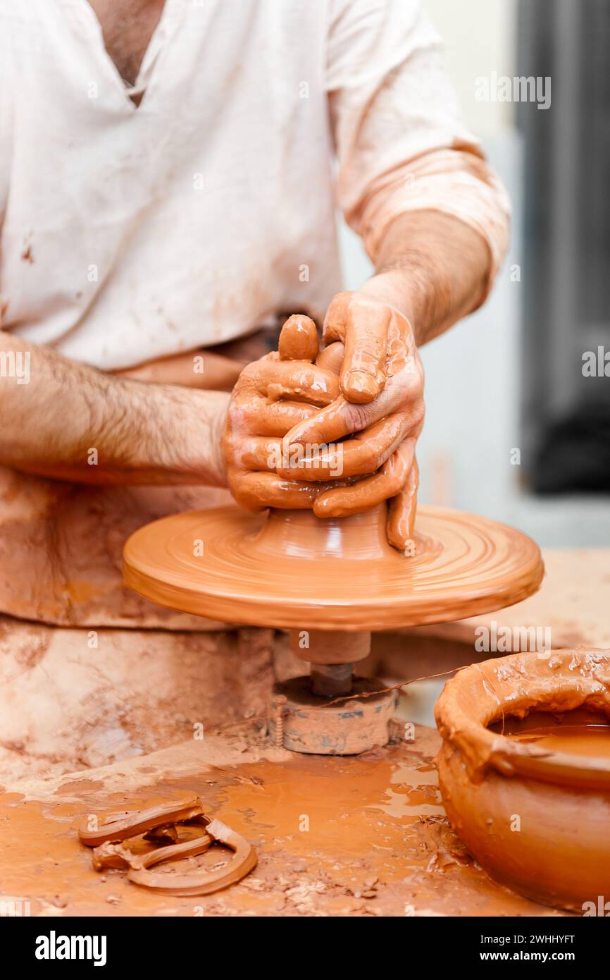 Potter working the clay with hands isolated in the foreground Stock Photo
