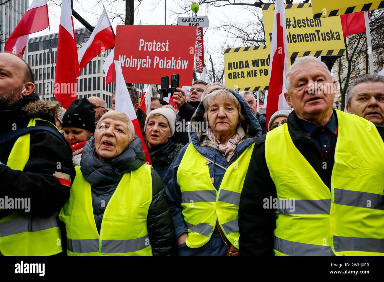 Warsaw, Poland, 10th of February, 2024. A crowd of people, holding Polish national flags and anti-government banners, led by far right media - Gazeta Polska and TV Republica and Law and Justice (Prawo i Sprawiedliwość - PIS) political party leaders stage a protest in support of current Constitutional Court Judges in front of the Court's building on Szucha Street. Poland goes through a constitutional crisis as current, centrist government says judges of Constitutional Court were illegally installed by former right-wing government. Right-wing opposition demonstrates a support of the Court Judges Stock Photo