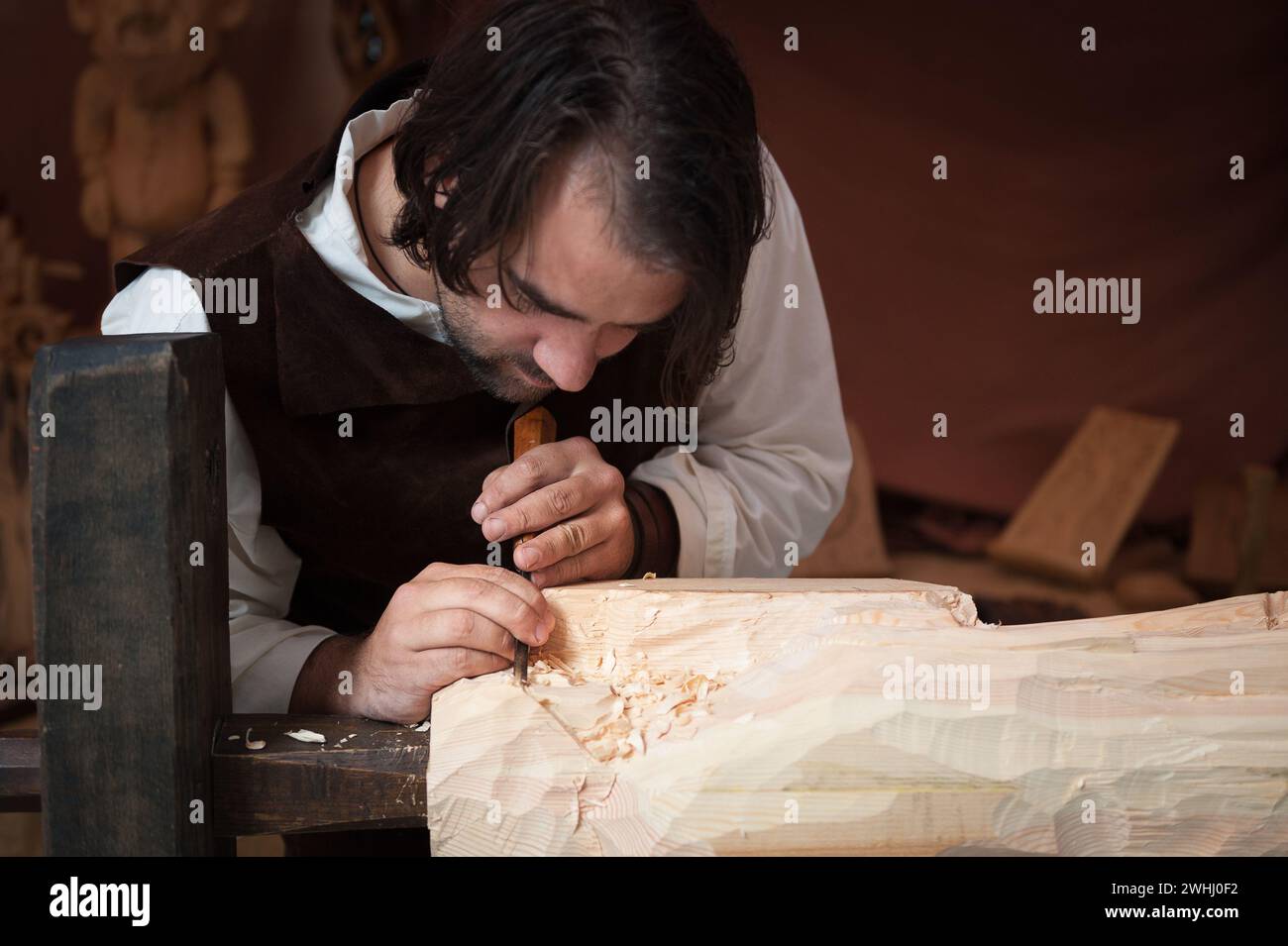 Wood worker with hand gouge working the Pine Stock Photo