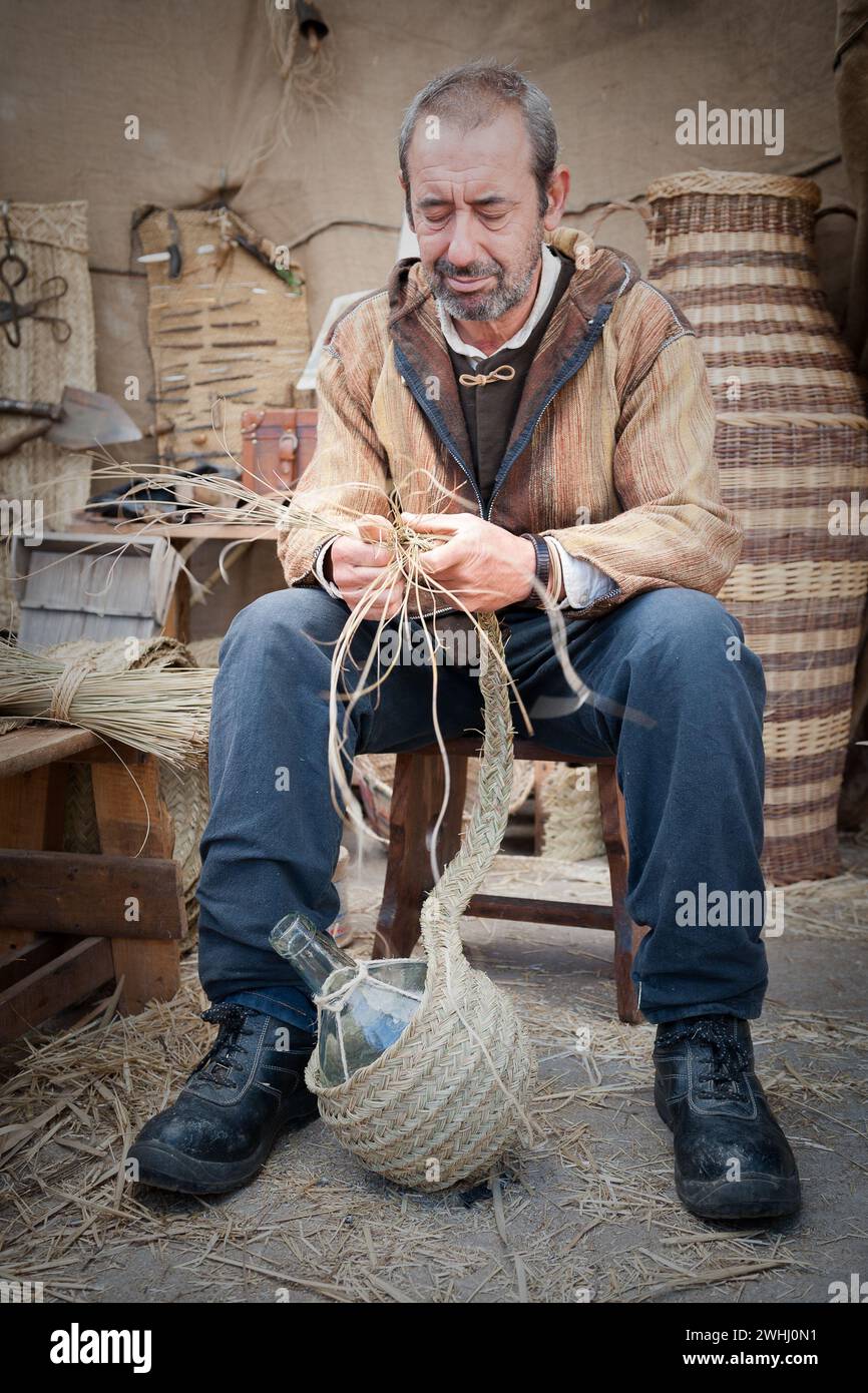 Close-up of man working wicker to make a final product Stock Photo
